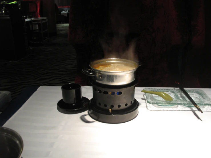 a stove sitting on top of a white table