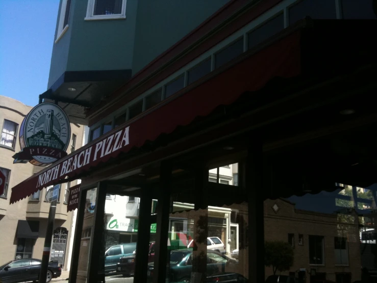 there is a pizza restaurant on the street corner