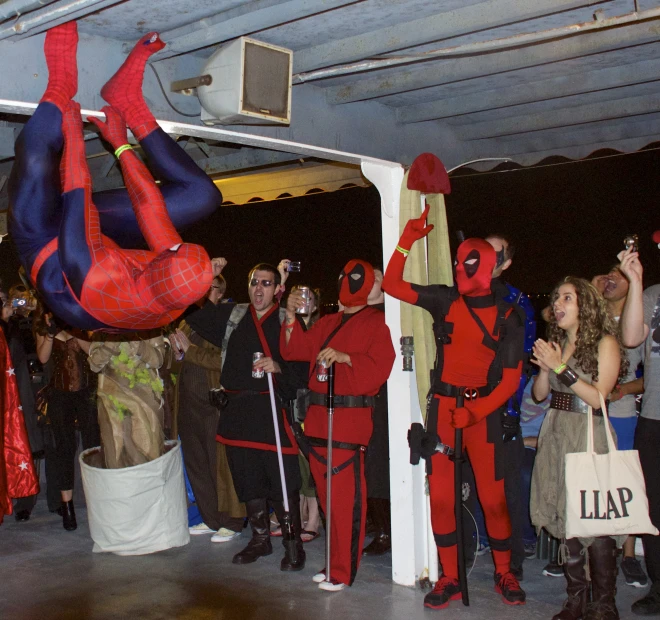 a group of people wearing costumes are standing near a white wall