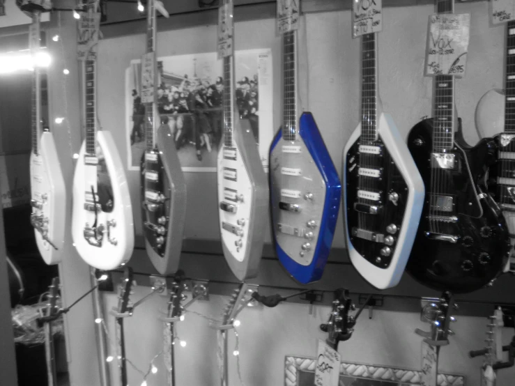 a wall with guitars all in blue, white and black