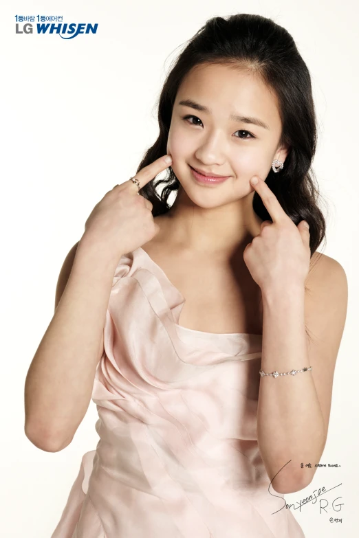 a young asian woman is wearing a pink dress