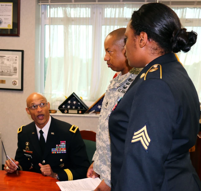 two military men, one in a suit and other in a dress shirt