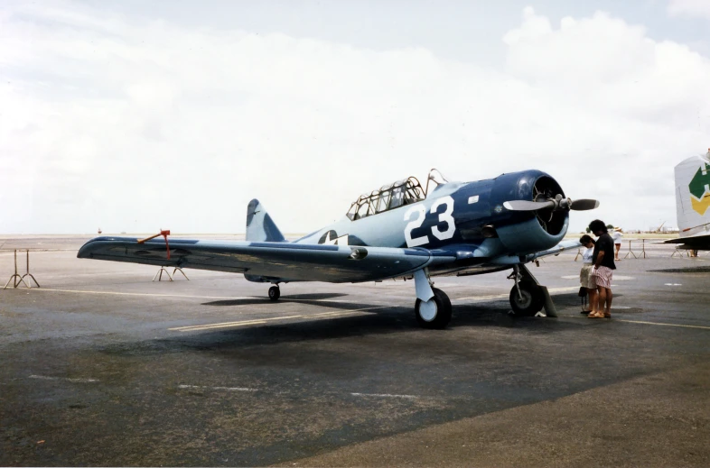 the old style airplane is parked on the runway