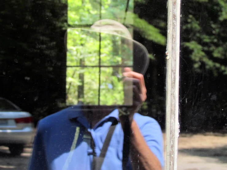 a man with his reflection is taking a picture