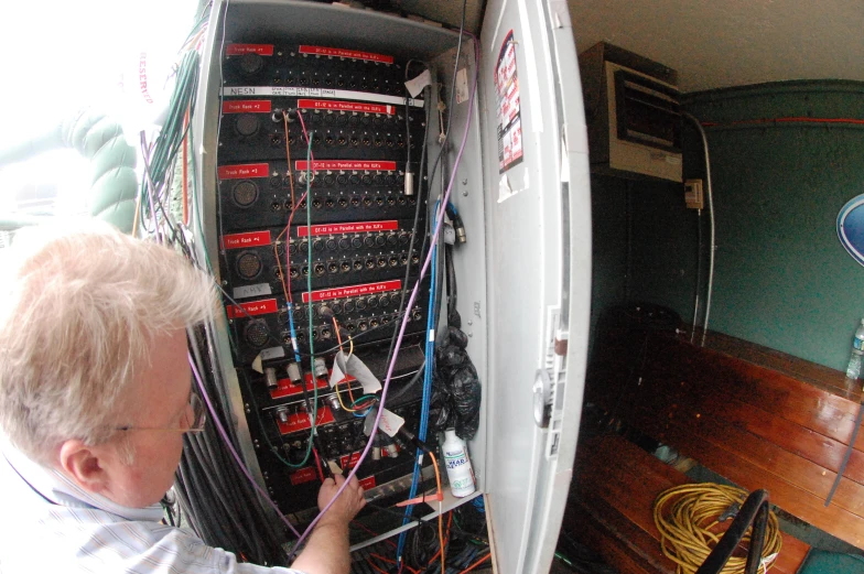 a man using wires to connect a cabinet