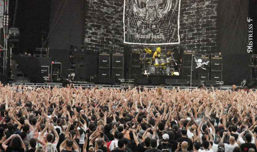 many people are in front of a large concert stage