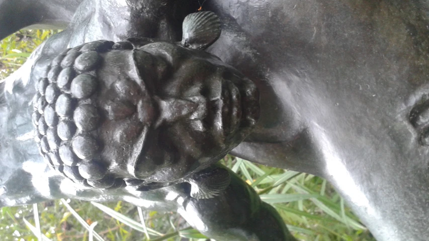 a statue of a woman's head and hands with other faces