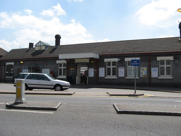 an image of a car parked in front of the train station