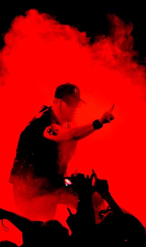 a person in front of a stage with smoke