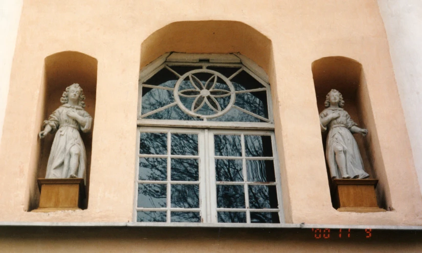 an old fashion statue is seen in the window