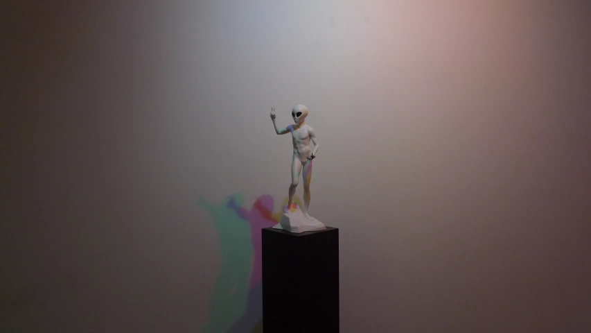 a white and black statue is in the corner