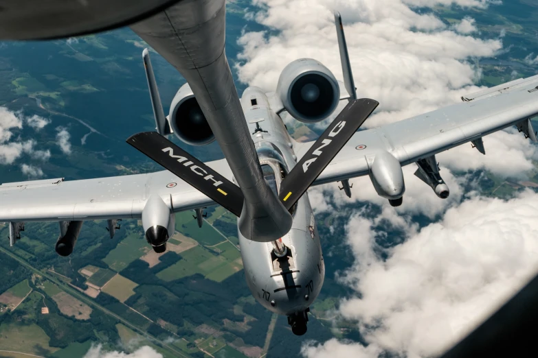 a propeller powered airplane is above the clouds