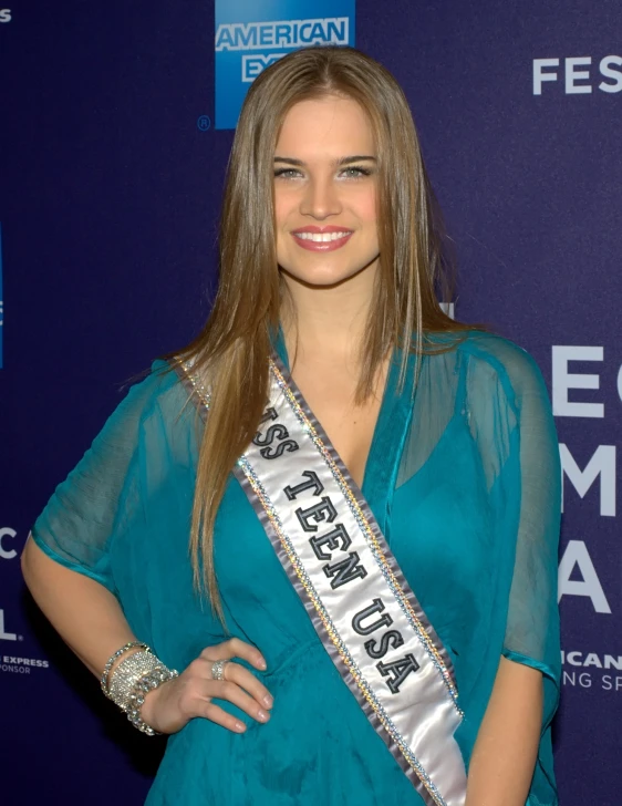 a pretty young lady posing in a teal dress