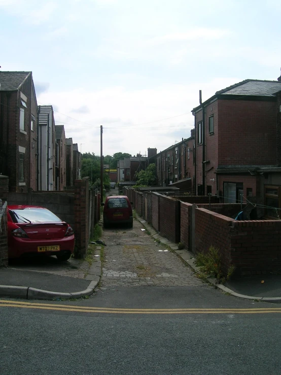 a brick street lined with brick homes with parking areas