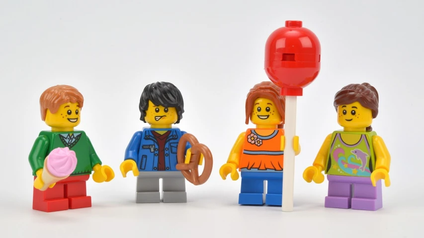 three lego figures, a girl and two boys are holding the same object