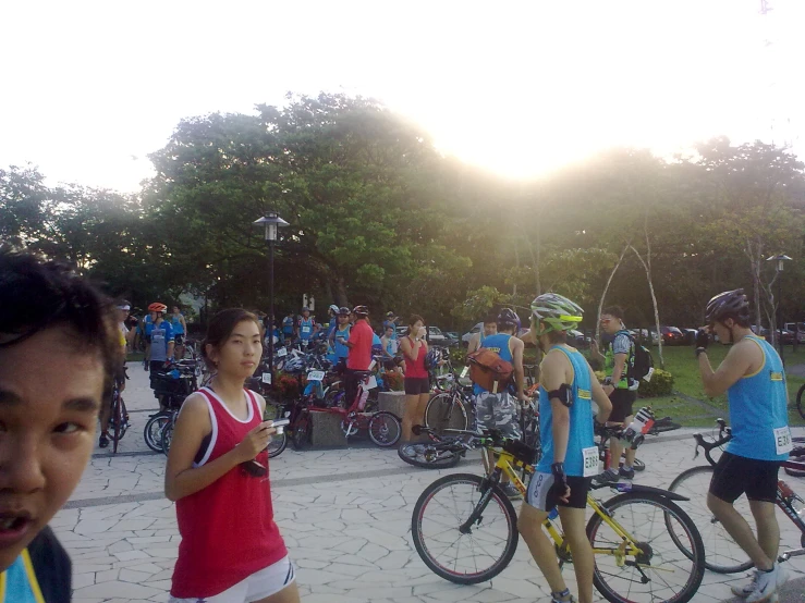 a group of people riding bicycles on a path