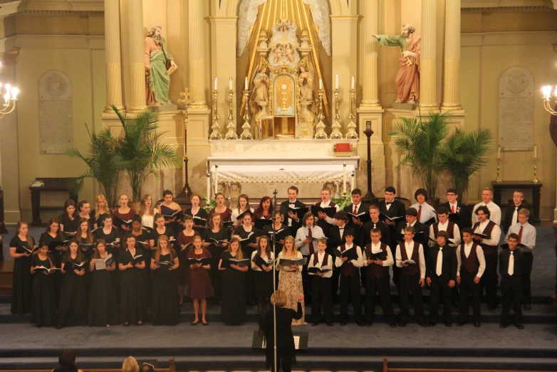 an orchestra with choir sings in front of the altar