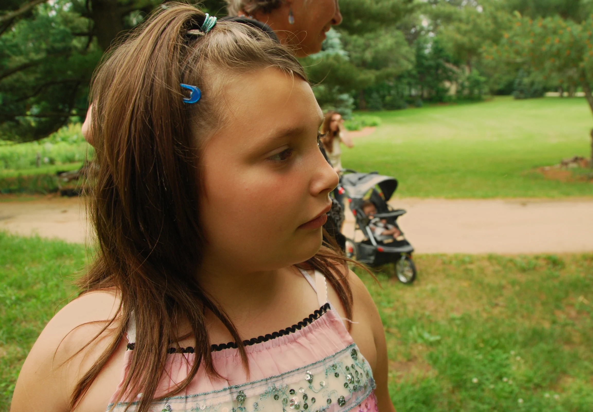 a little girl holding a banana peel next to her ear