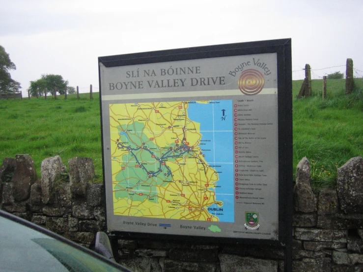 a sign next to a road stating a tour