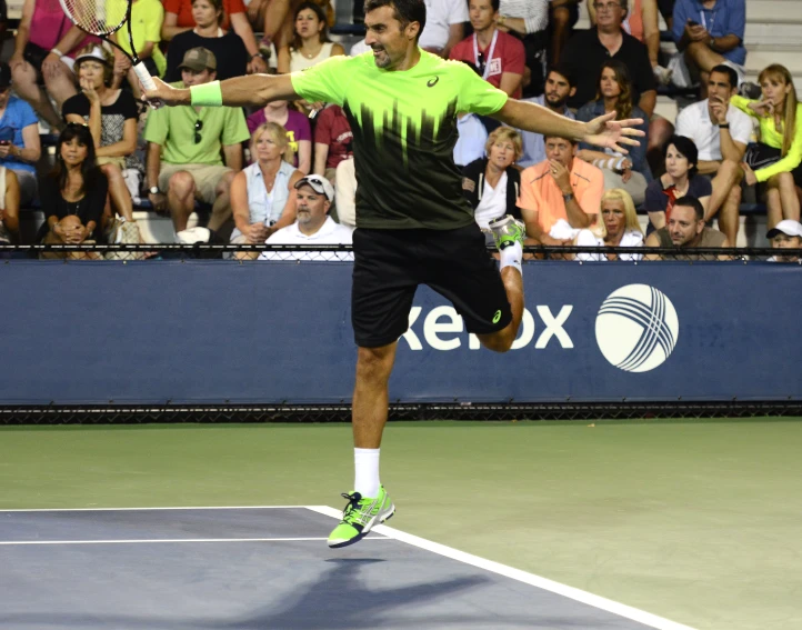 a tennis player getting ready to swing at a ball