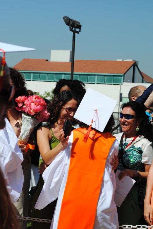 a woman has been dressed in white and an orange dress