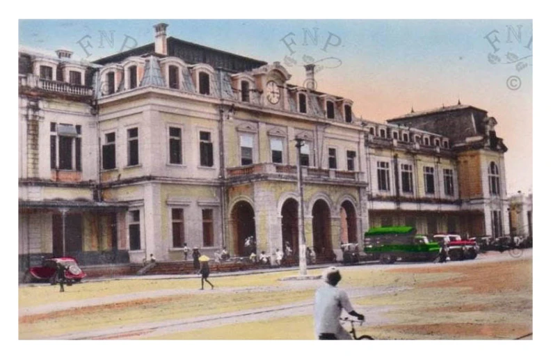 old city street with large buildings, people and cars