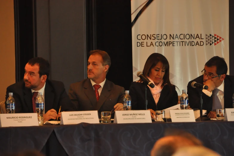 four people sit on a panel during an event