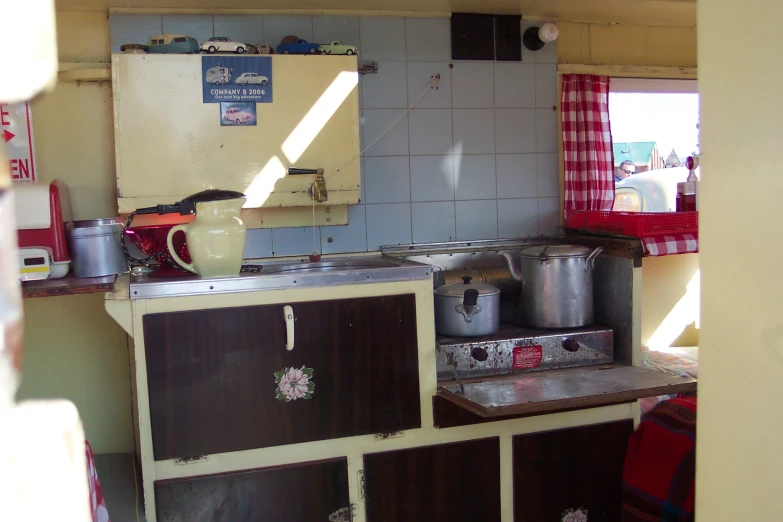 kitchen area with sink, stove and various cooking utensils