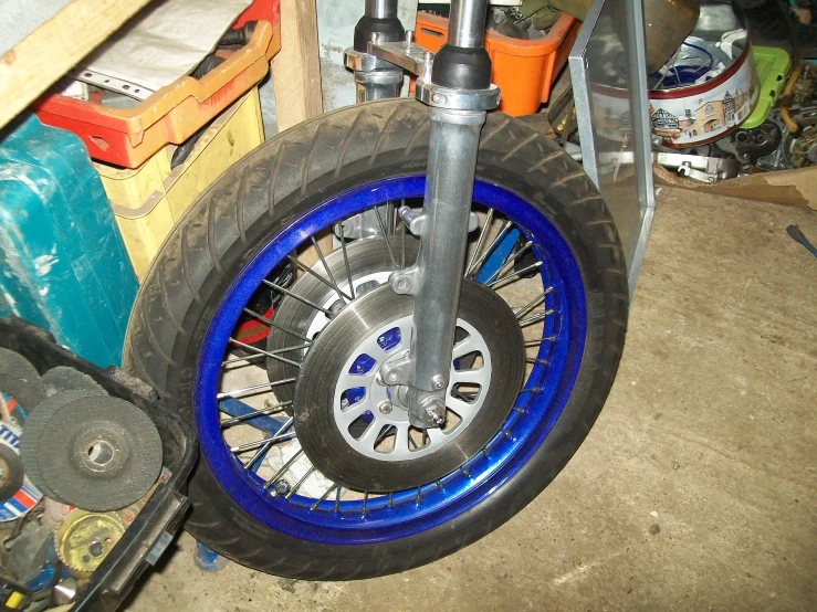 the tire of a motor cycle that's painted blue
