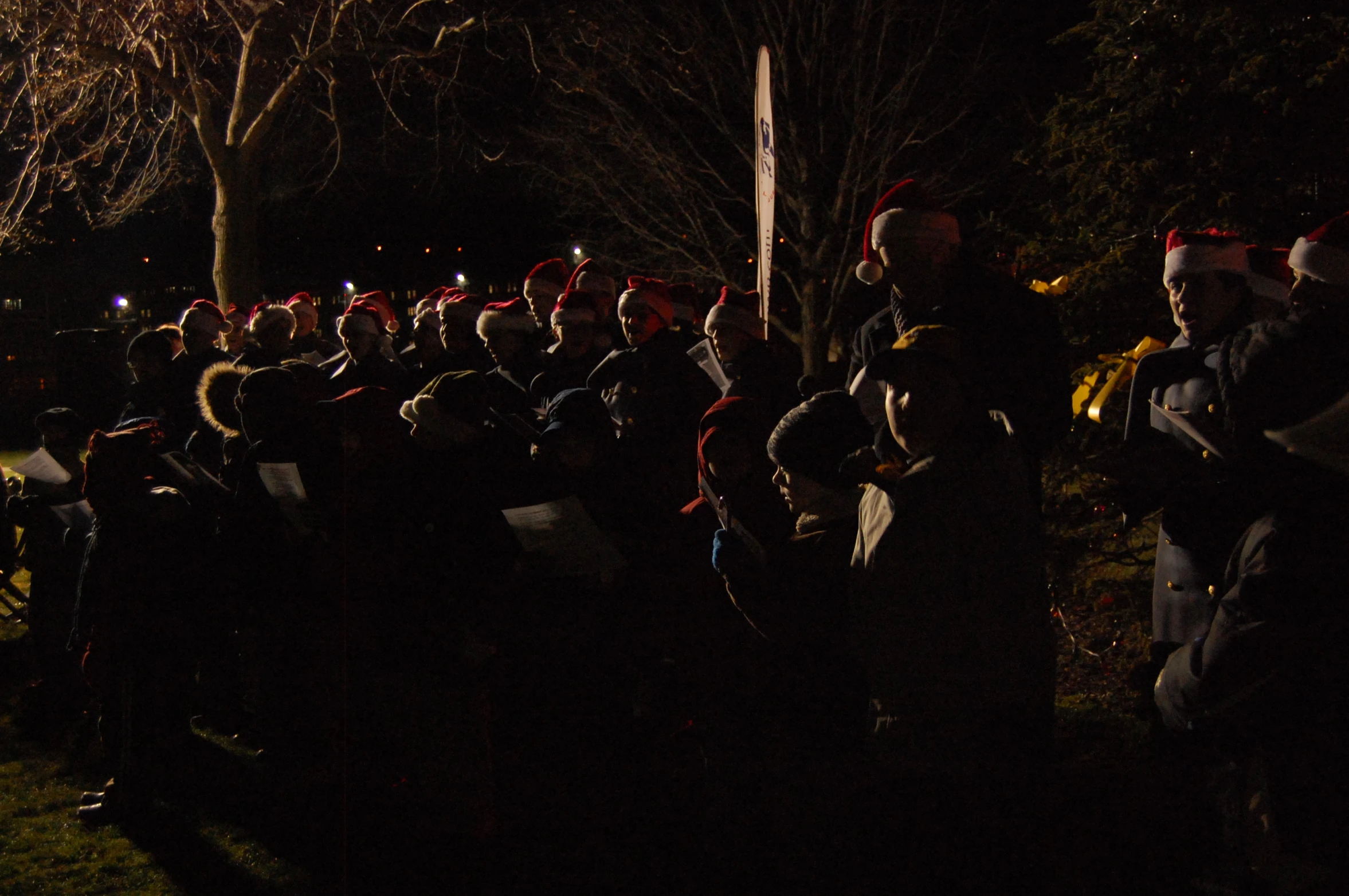 a group of people dressed up as santa clause at night