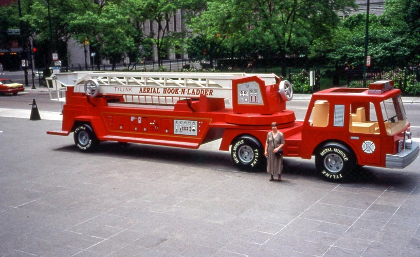 a woman standing next to a fire truck