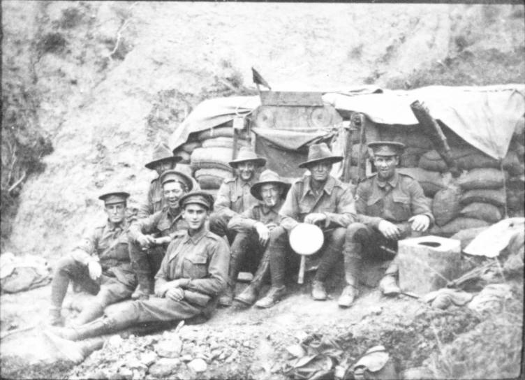 black and white po of soldiers sitting on the side of a hill