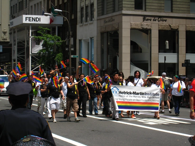 a group of people walk down the street while holding flags