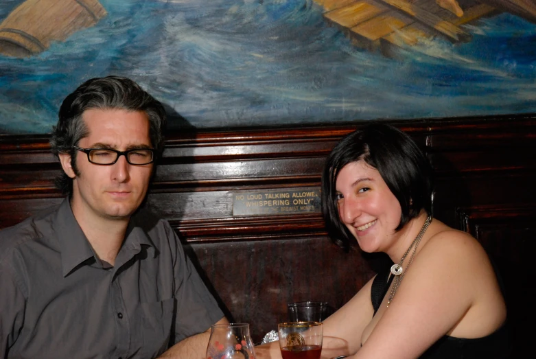 a couple at a restaurant enjoying drinks together