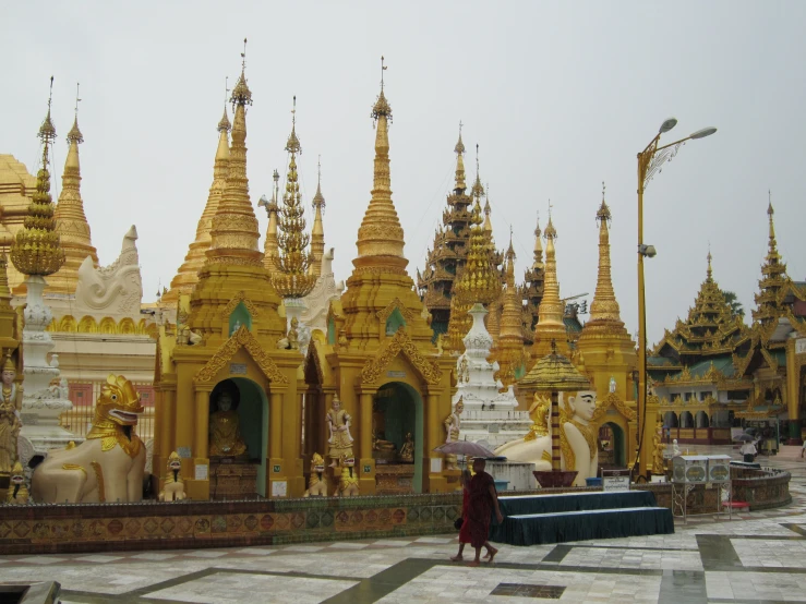 there are many golden buildings with statues in the middle