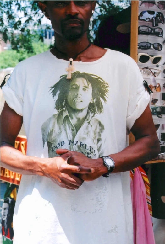 a man with glasses and a reggae poster on a t - shirt