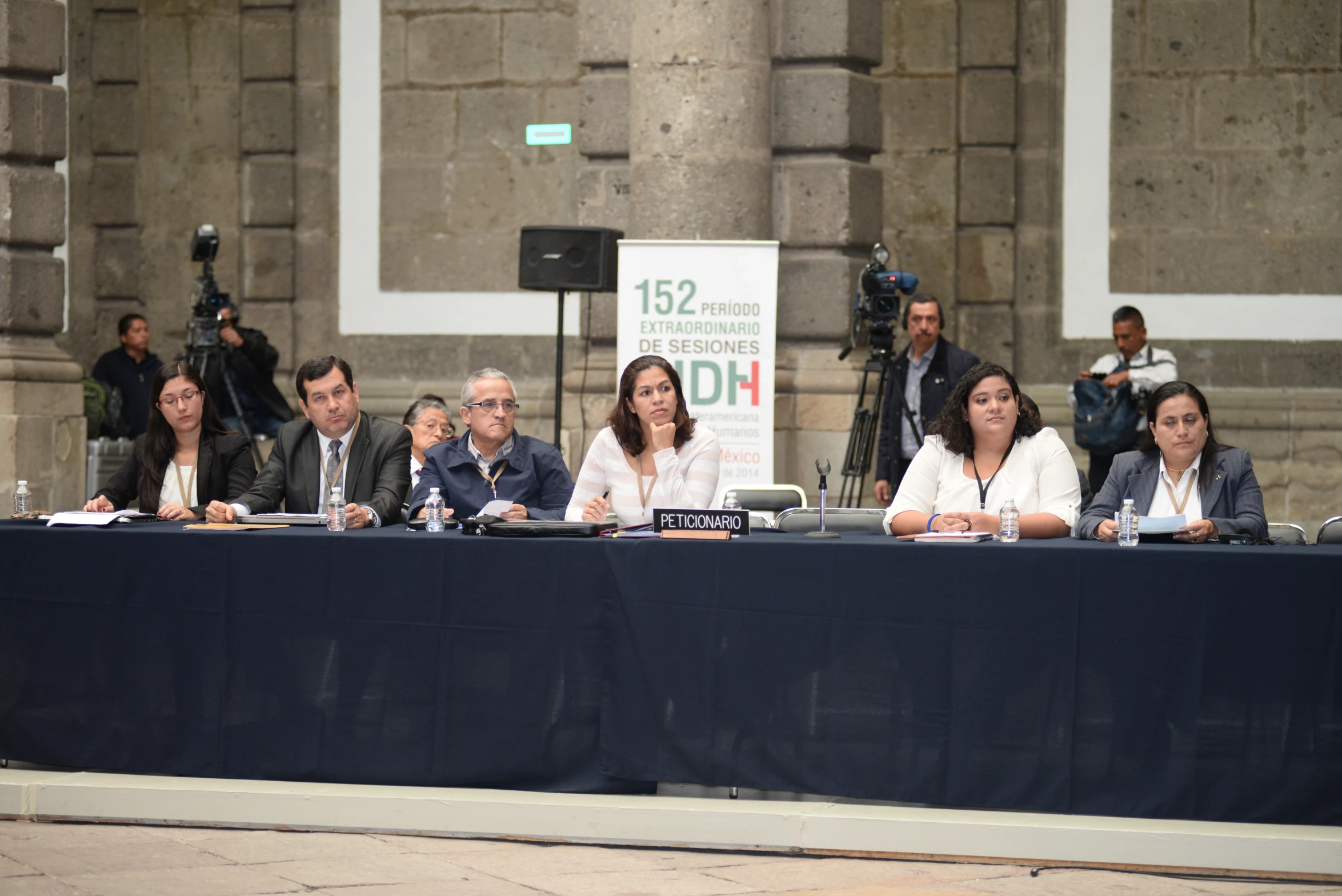 several people sit at a table for an event