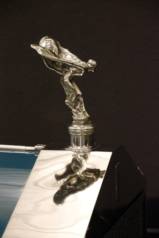 an award trophy sits on top of a book