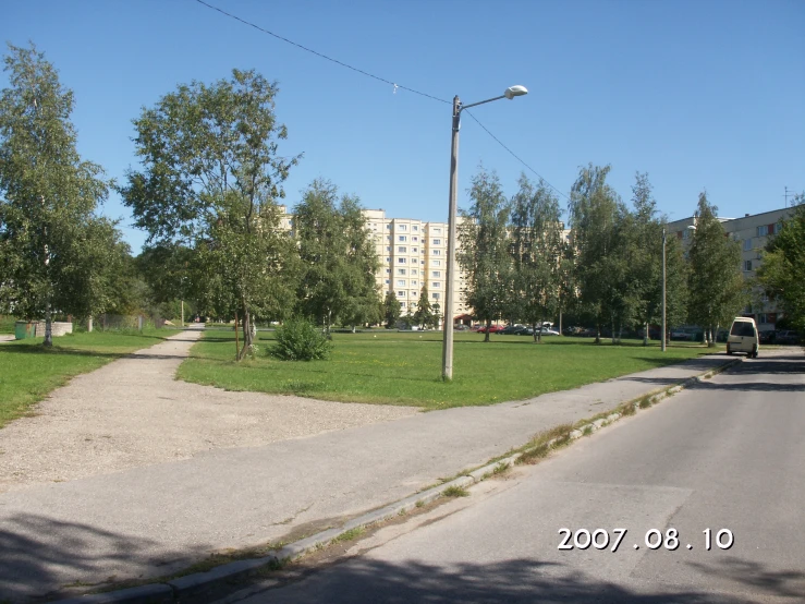 the road passes by some tall buildings and trees