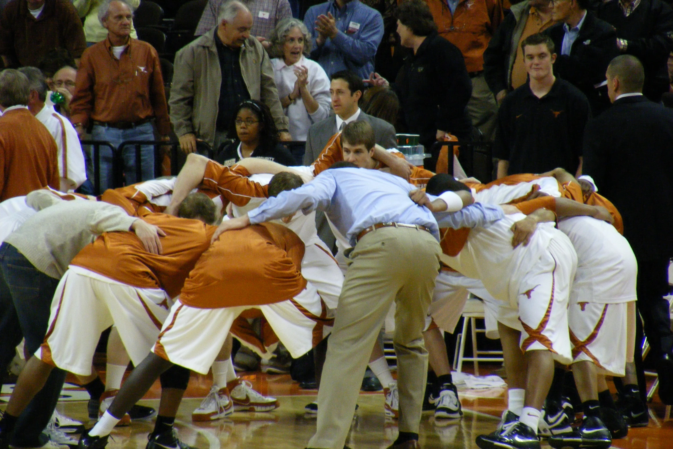 the referee is standing in front of his team while one man covers his face with his hands