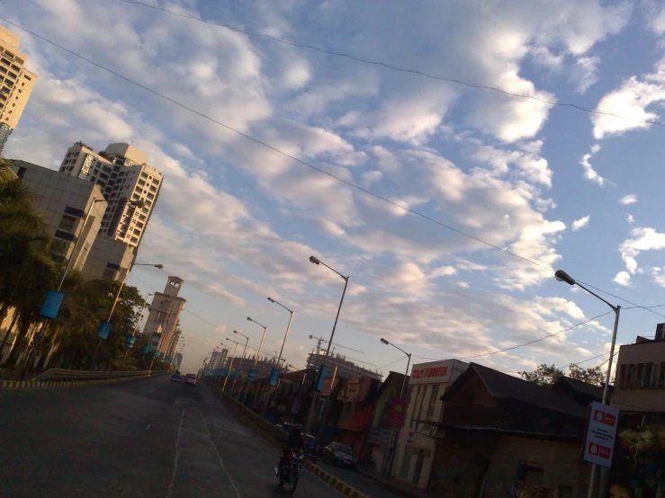 an empty road in front of tall buildings