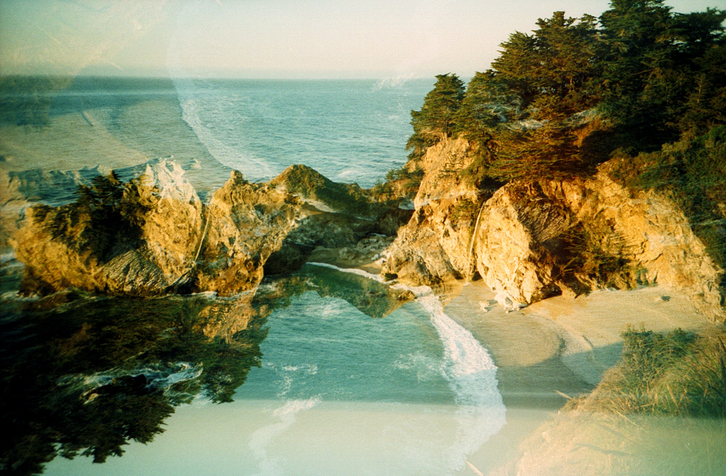 an aerial view of a river running through a cliff