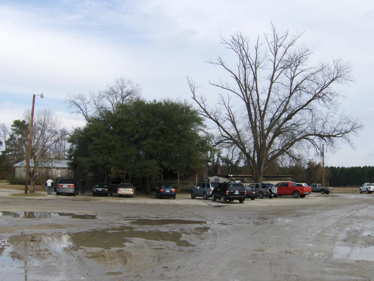 a bunch of cars parked in a lot on the side of a road