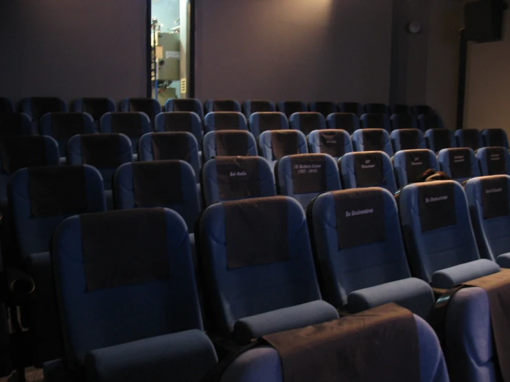 blue leather seats in an empty auditorium