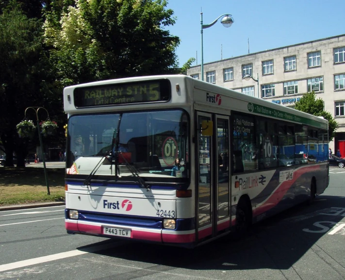 the bus is turning right in the center of the city