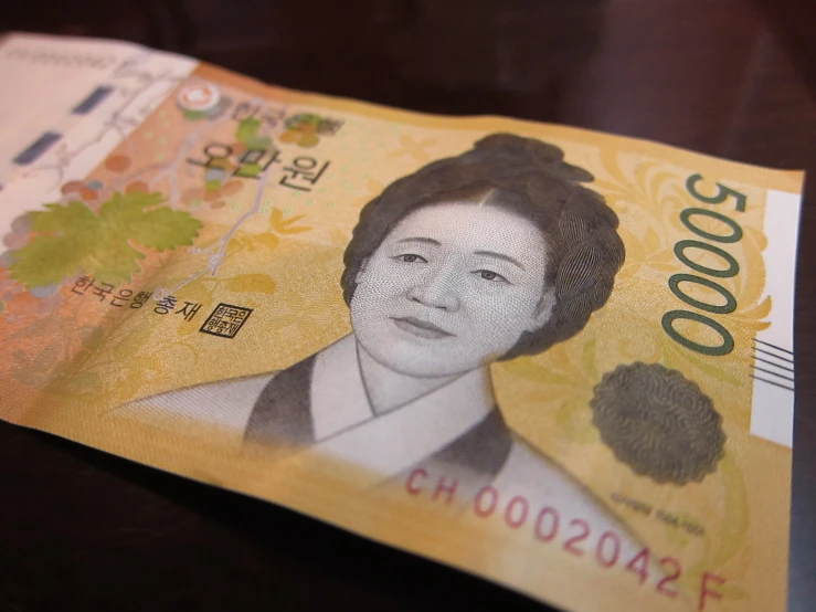 a hong dollar note is placed on a table