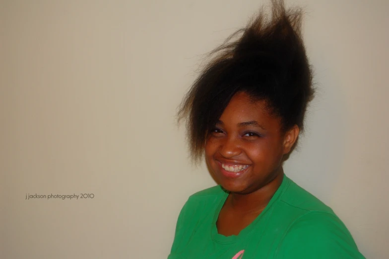 a girl with a weird hairdo and green shirt