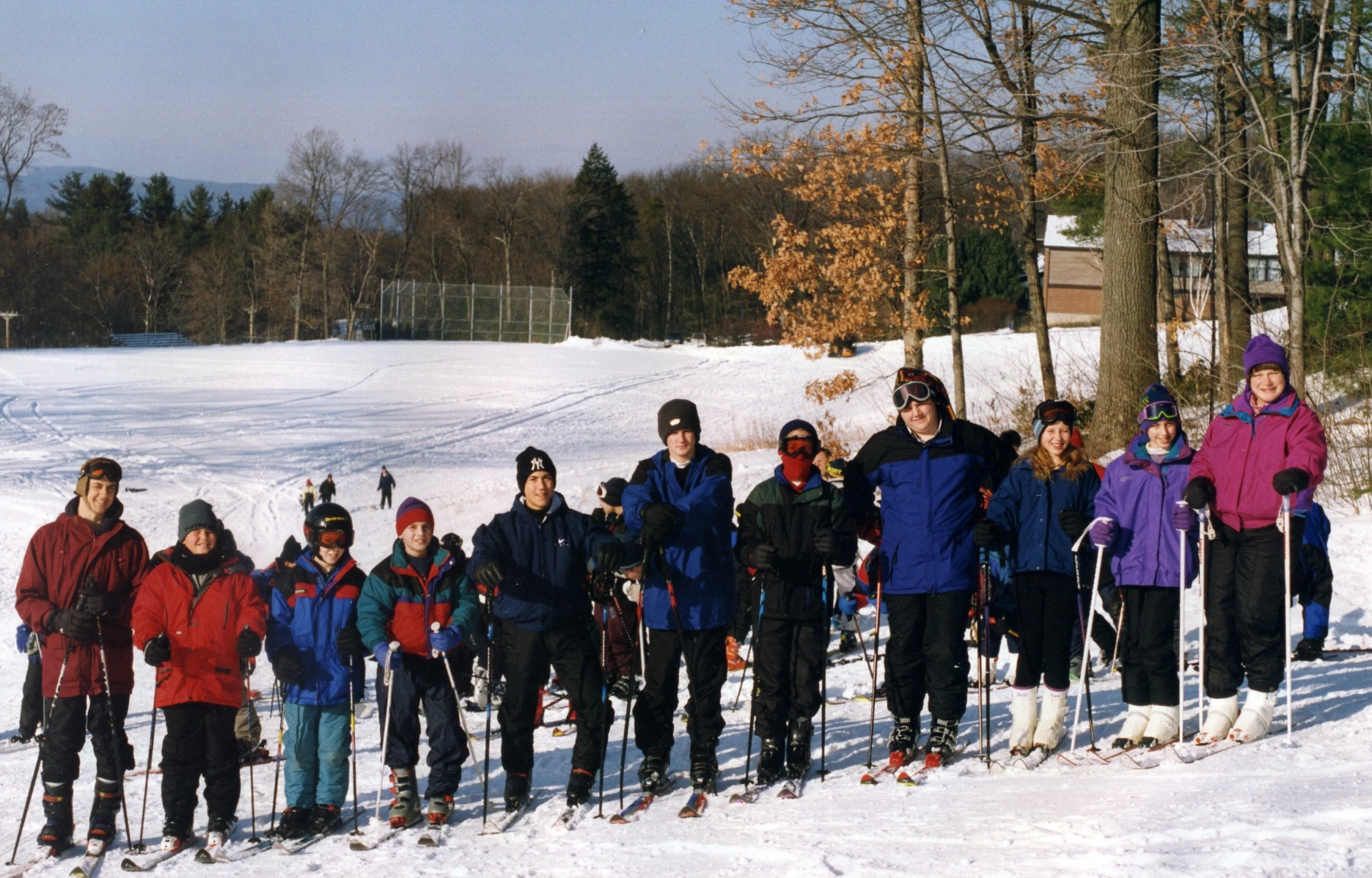 a group of skiers are standing in front of a snowy landscape