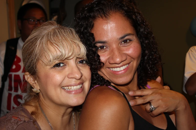 two women posing for the camera, one is laughing