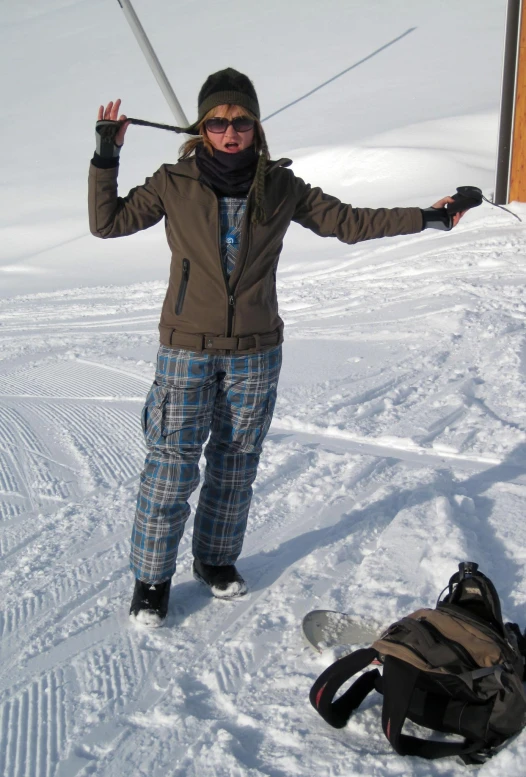 a woman holds ski poles in front of her in the snow